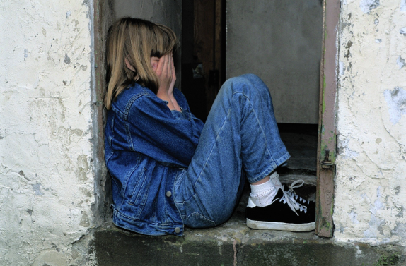 sad girl with ADHD in corner